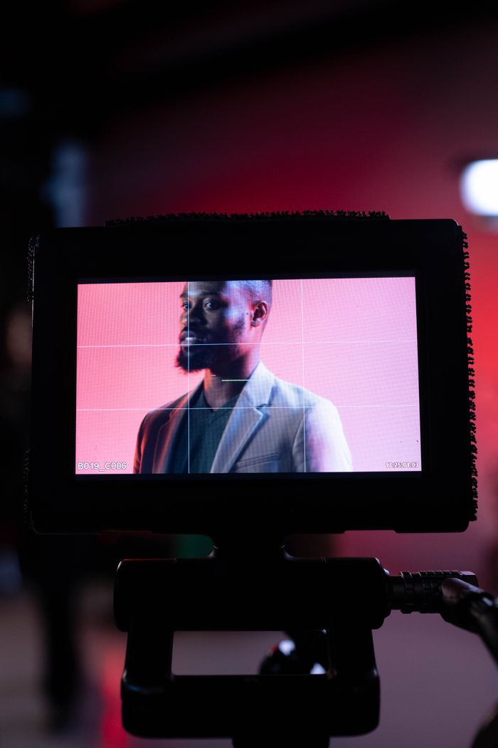 The Art of Drawing Readers In: Your attractive post title goes here Portrait of a man on a monitor, capturing a behind-the-scenes film production moment.
